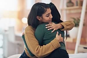 two women comforting each other