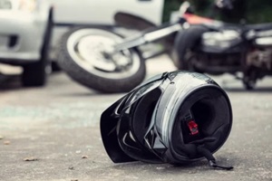 close-up of a helmet of a driver with a blurred motorbike and car in the background